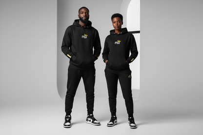 Two people wearing matching black outfits with a logo in a neutral setting